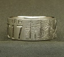 This 2 line 10mm titanium elk ring was designed around an image of the elk that hangs out in the clients front yard