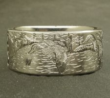 A committed pair of locked up mallards in a forest lake on a 2 line duck band