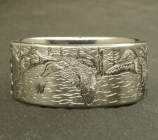 A committed pair of locked up mallards in a forest lake on a 2 line duck band