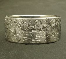 A committed pair of locked up mallards in a forest lake on a 2 line duck band