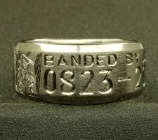 Beveled edge 2 line titanium ring with clients 2 bird dogs a locked up duck and an airboat in the proper setting