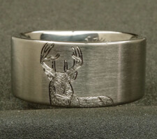 Ring depicting a deer and tree with the couple's initial's carved in it