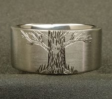 Ring depicting a deer and tree with the couple's initial's carved in it