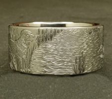 A ring depicting a dog and duck