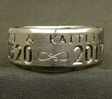A Custom titanium ring with wedding date & name engraved designed by Dave Kessner.