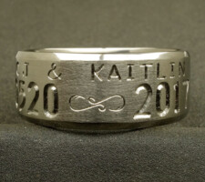 A Custom titanium ring with wedding date & name engraved designed by Dave Kessner.