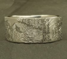Ring depicting a duck and a tractor in a field