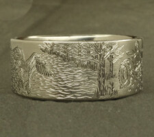 Ring depicting a duck and a tractor in a field
