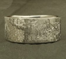 Ring depicting a duck and a tractor in a field