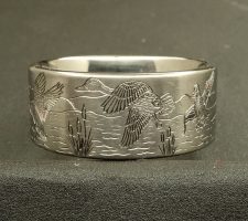 Hand engraved wedding band with flying ducks