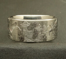 Hand engraved wedding band with flying ducks