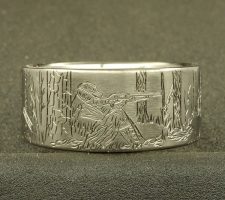A ring depicting a hunter aiming his gun at a turkey
