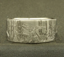 A ring depicting a hunter aiming his gun at a turkey