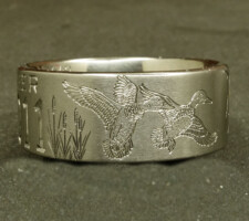 Two line titanium duck ring with committed pair of mallards and cattails. With a crossed shotgun and fishing pole with family initials