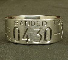Two line titanium duck ring with committed pair of mallards and cattails. With a crossed shotgun and fishing pole with family initials