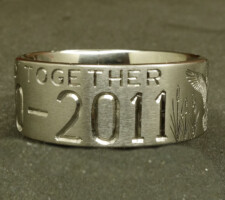 Two line titanium duck ring with committed pair of mallards and cattails. With a crossed shotgun and fishing pole with family initials