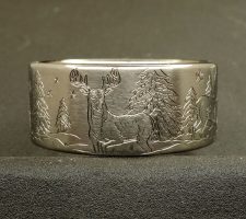 Titanium Deer ring with the buck and doe in a winter setting
