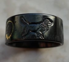 A black zirconium wedding band with a hunting dog designed by Dave Kessner.