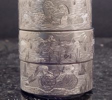 Three stacked rings depicting waterfowl and wildlife