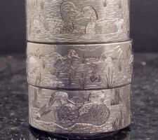 Three stacked rings depicting waterfowl and wildlife