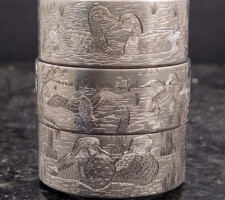 Three stacked rings depicting waterfowl and wildlife