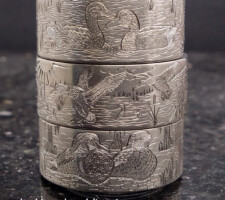 Three stacked rings depicting waterfowl and wildlife