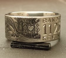 Titanium duck ring showing part of an engraved wedding date and the word banded
