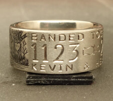 Titanium duck ring showing part of an engraved wedding date and the word together
